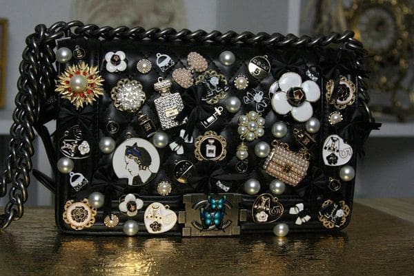 A black purse with many different buttons on it