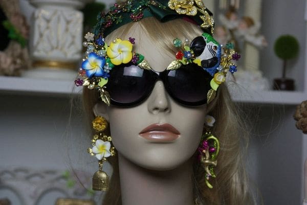 A mannequin wearing sunglasses and floral headpiece.