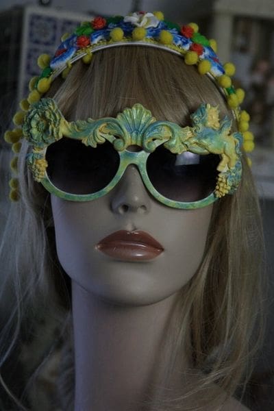 A mannequin wearing sunglasses with yellow flowers on them.