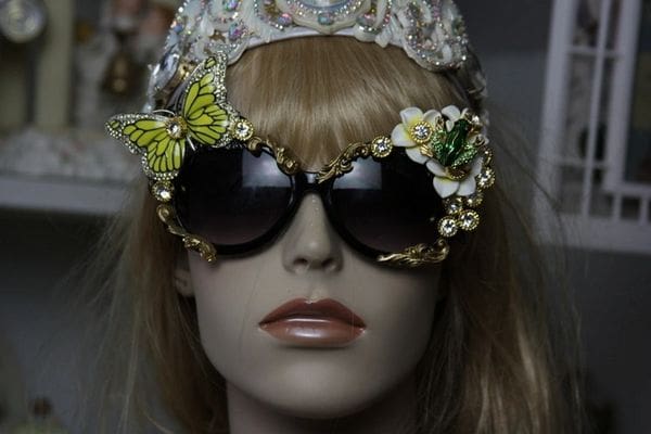 A mannequin wearing sunglasses with butterflies on them.