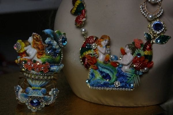 A close up of some jewelry on top of a purse