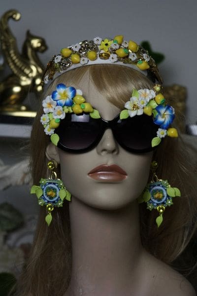 A mannequin wearing sunglasses and a crown.