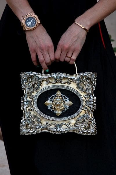A woman holding onto a purse with a picture of a person