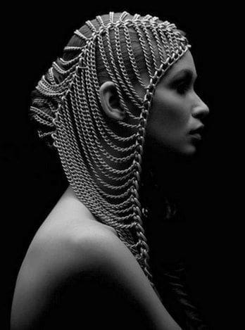 A woman with long hair and chains on her head.