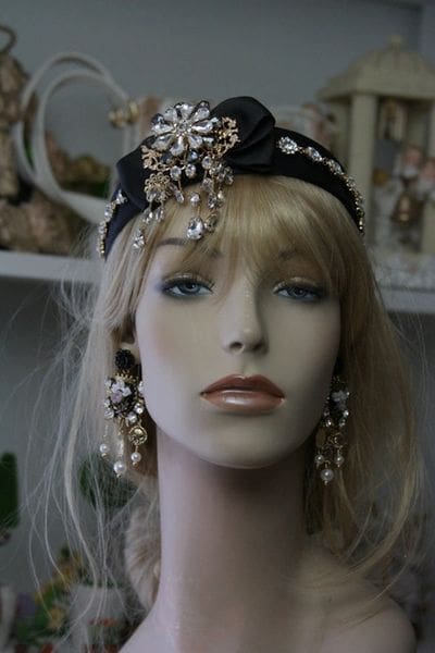 A mannequin wearing earrings and a head piece.