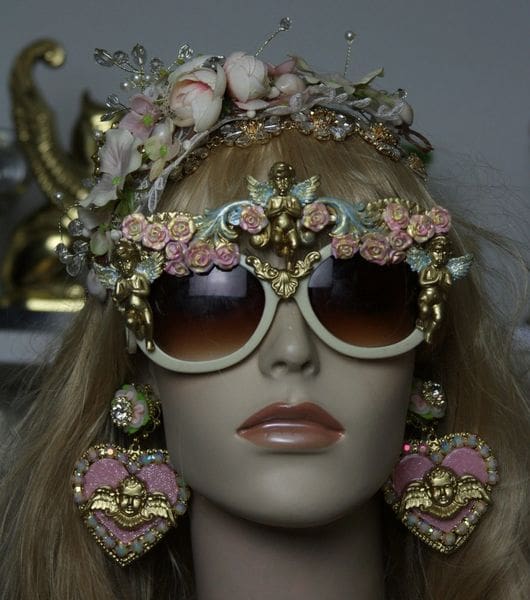 A mannequin wearing sunglasses and a crown.