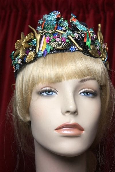 A mannequin wearing a colorful crown with flowers.