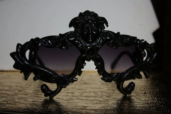 A pair of sunglasses with black frames on top of a table.