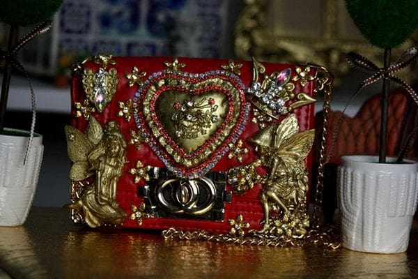 A red purse with gold embellishments on it.