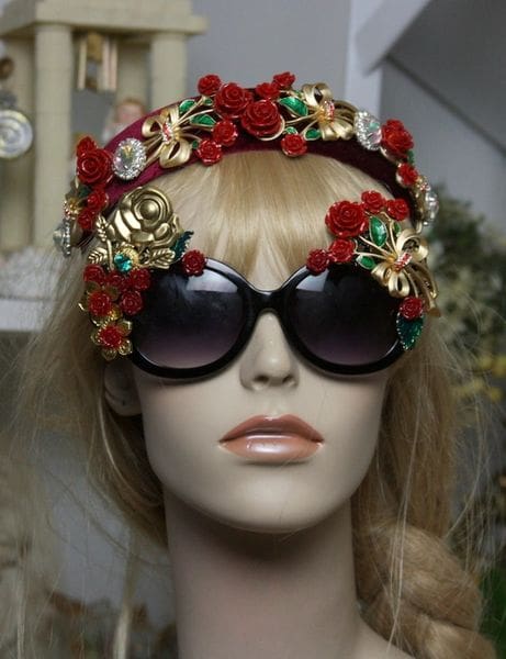 A mannequin wearing sunglasses and a floral headband.