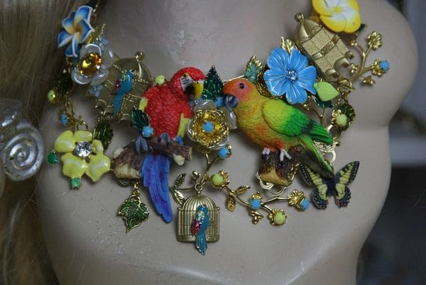 A necklace with many different colored birds and flowers.