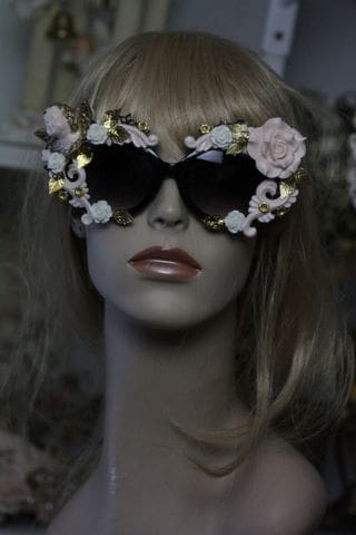 A mannequin wearing sunglasses with flowers on them.
