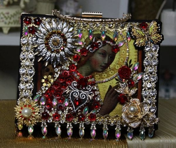 A picture of a woman with flowers and jewels.