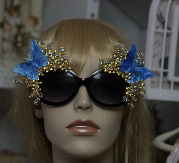 A mannequin wearing sunglasses with blue butterflies on them.