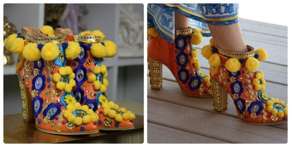 A pair of shoes with yellow pom poms and gold beads.