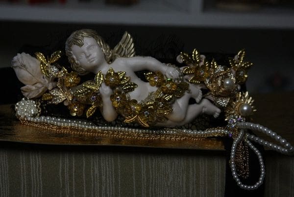 A statue of an angel is sitting on the ground.
