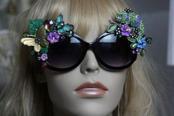 A mannequin wearing sunglasses with flowers on them.
