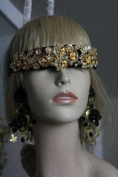 A mannequin wearing a head piece and earrings.