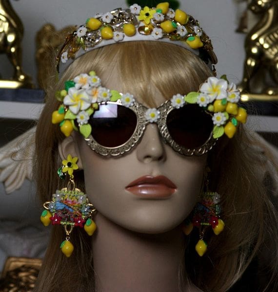 A mannequin wearing sunglasses and headpieces.