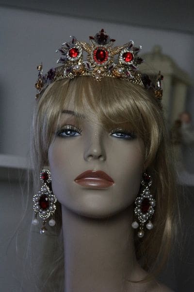 A mannequin wearing a crown and earrings.