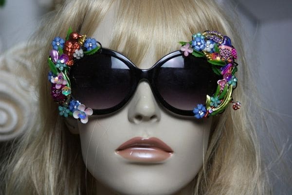 A mannequin wearing sunglasses with flowers on them.
