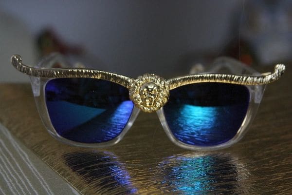 A pair of blue sunglasses sitting on top of a table.