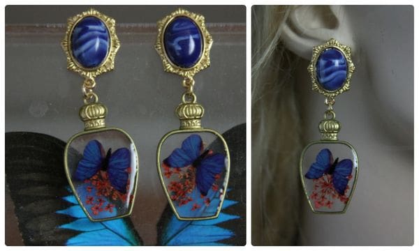 A pair of earrings with blue butterflies in them.