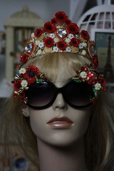A mannequin wearing sunglasses and a crown.