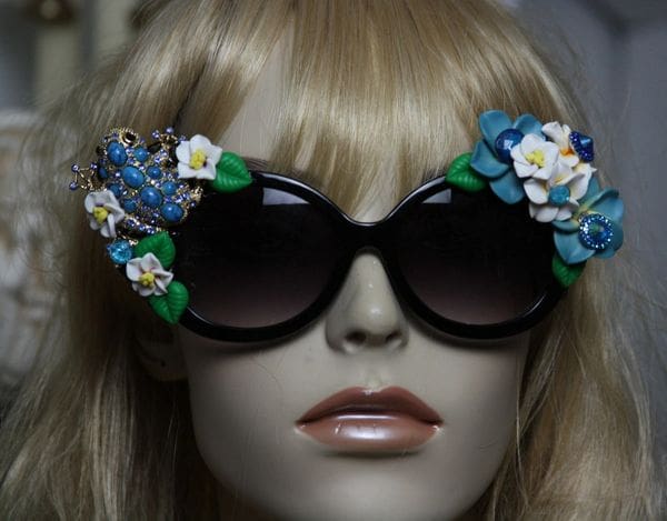 A mannequin wearing sunglasses with flowers on them.