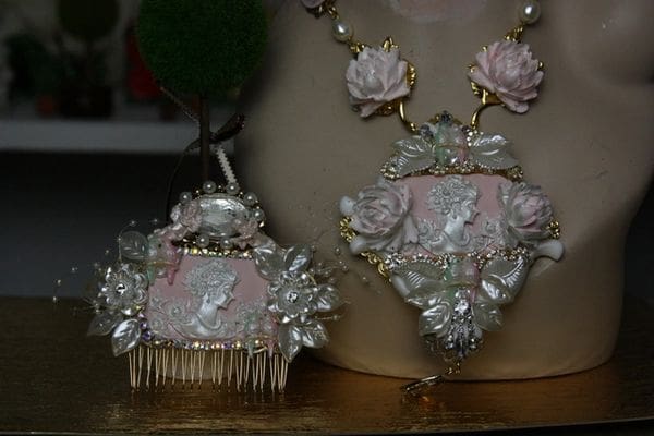 A necklace and comb set with pink flowers.