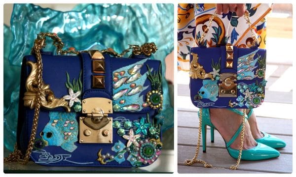 A blue purse with sea creatures on it and a pair of high heels.