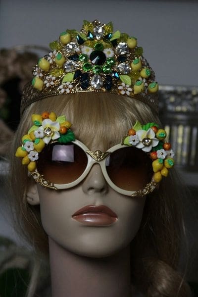 A mannequin wearing sunglasses and a crown.