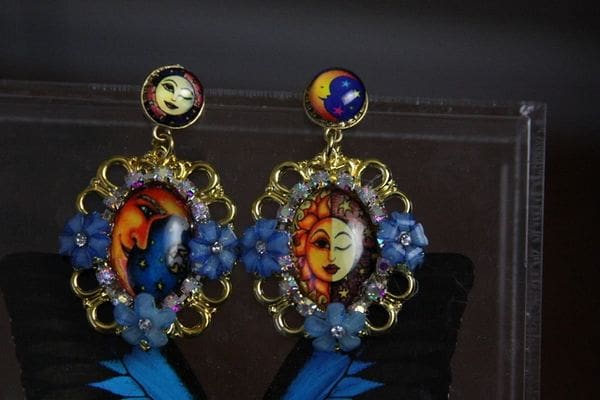 A pair of earrings with faces on them.