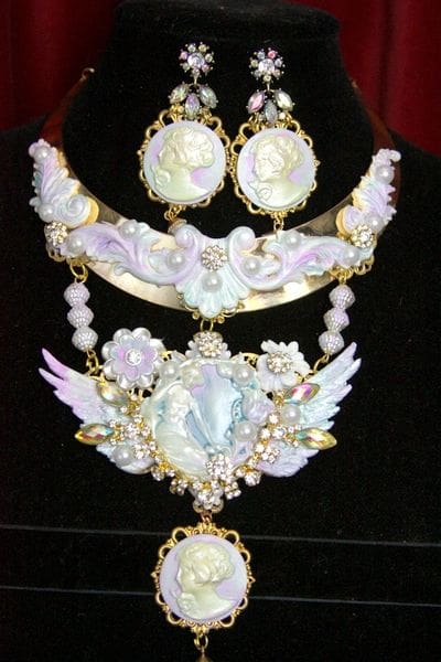 A necklace and earrings set with white, pink and gold design.