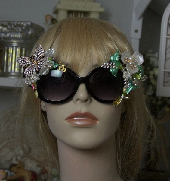 A mannequin wearing sunglasses with flowers on them.