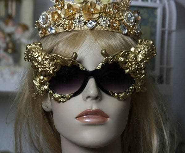 A mannequin wearing sunglasses and a crown.
