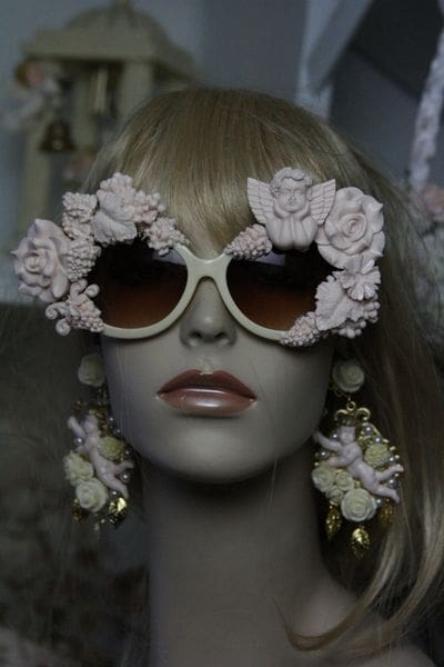 A mannequin wearing sunglasses with flowers on them.
