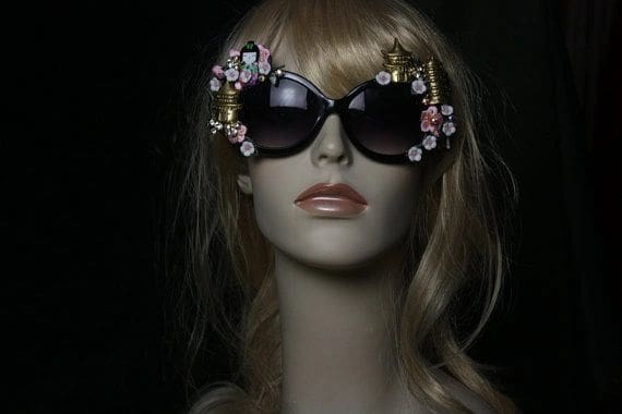 A mannequin wearing sunglasses with flowers on them.