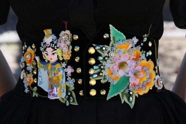 A close up of the back of a black jacket with flowers
