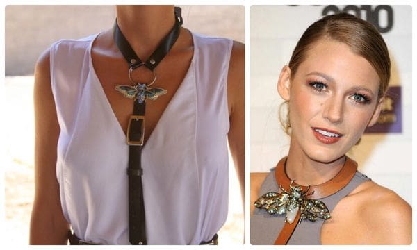 A woman wearing a necklace with a bird on it.