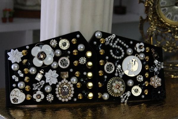 A black and white purse with many buttons on it
