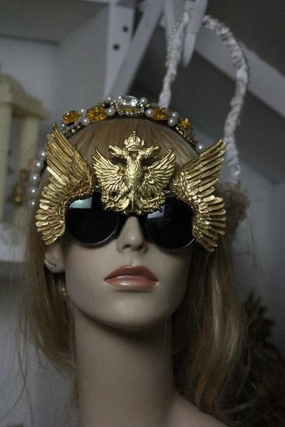 A woman wearing sunglasses and a crown.