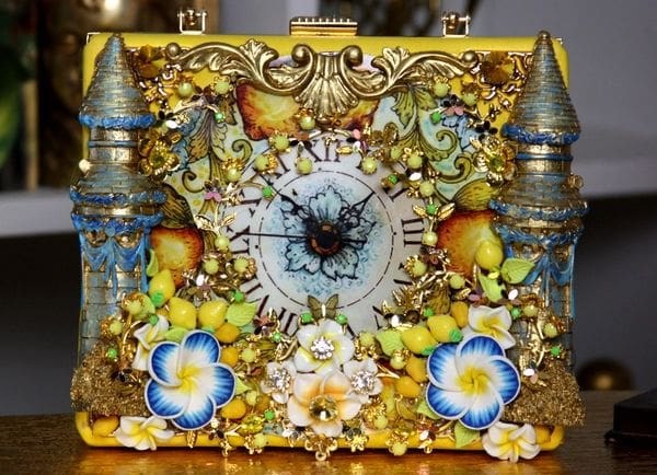 A clock with flowers and butterflies on it.