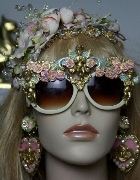 A mannequin wearing sunglasses and headpieces.