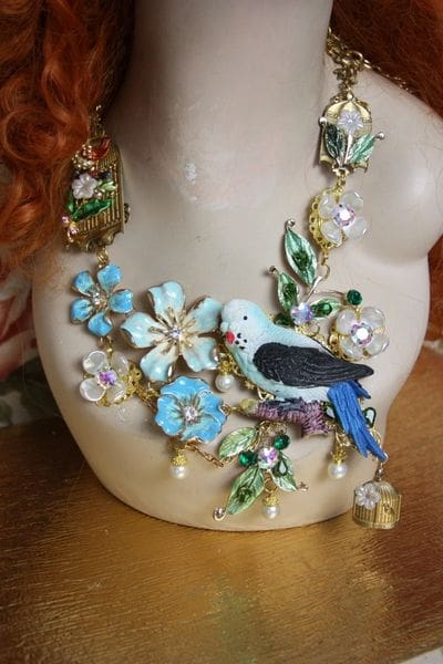 A close up of a necklace with flowers and birds