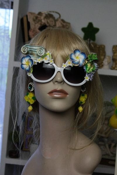 A mannequin wearing sunglasses with flowers on them.