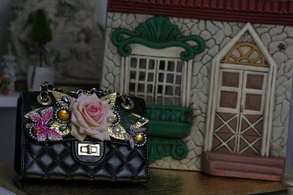 A close up of a purse with a rose on it