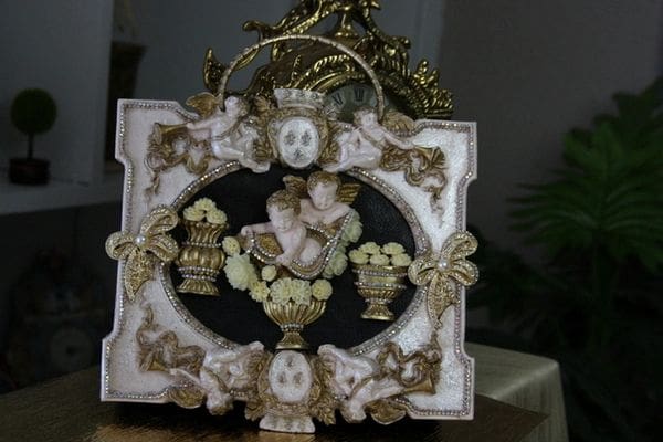 A picture frame with some gold and white decorations