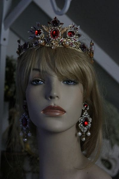 A mannequin wearing a crown and earrings.