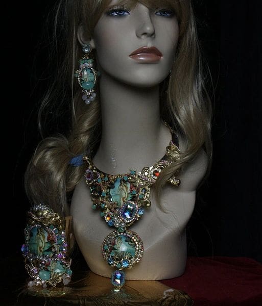 A mannequin wearing jewelry and earrings.